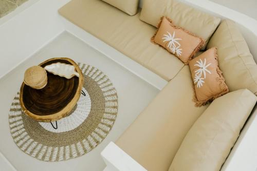 a table with a hat on top of a couch at Villas Tamu 1 in Bingin Beach