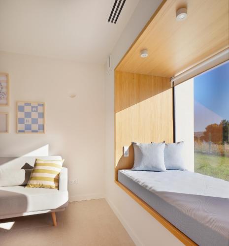 a bedroom with a bed and a window at Apartamentos Lobamar in Gijón