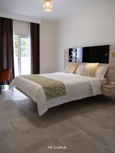 En eller flere senge i et værelse på Meluna