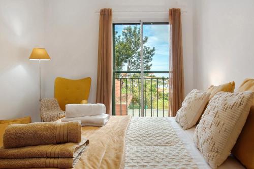 a bedroom with a large bed and a window at Casa Nóbrega in Caniço