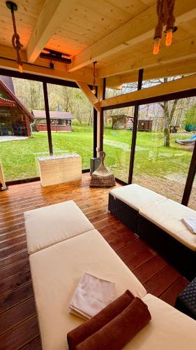 a room with two beds on a wooden floor at PARADiSE Wellness Chalet - Sauna&SPA Terchová in Terchová