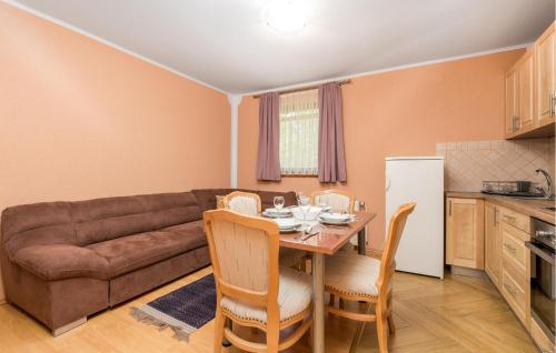 a kitchen and dining room with a table and a couch at Amazing Apartment In Vrbovsko With Sauna in Vrbovsko