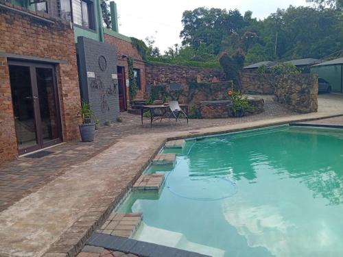 a swimming pool in front of a building at An Exclusive Guesthouse too in Nelspruit