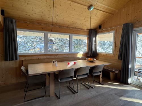 a dining room with a large wooden table and chairs at Chalet Bastion in Brandstätter