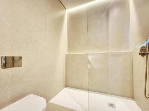 a bathroom with a toilet and a glass shower at Antonia Luxury Home in Seville
