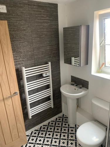a bathroom with a toilet and a sink at Modern flat in Cardiff Bay in Cardiff