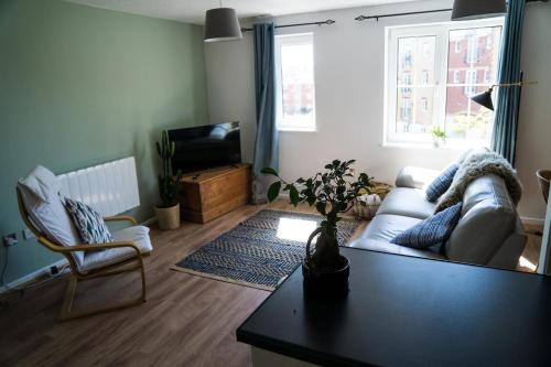 a living room with a couch and a table at Modern flat in Cardiff Bay in Cardiff