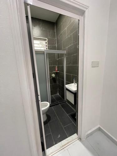 a bathroom with a toilet and a sink at Qaseh homestay in Kota Bharu