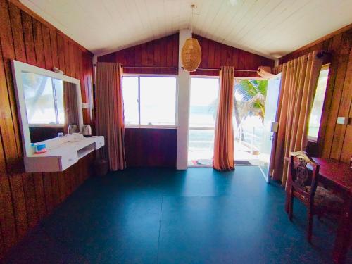 a living room with a view of the ocean at Why Not Guest house in Hikkaduwa