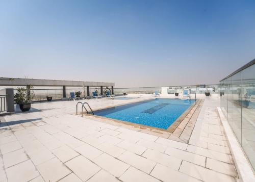 a swimming pool on the roof of a building at Free housekeeping visits during your stay - StayShort - Dubai South 1BR sleeps 4 in Dubai Marina