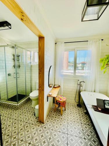 a bathroom with a shower and a toilet and a tub at Central Santiago Haven in Santiago