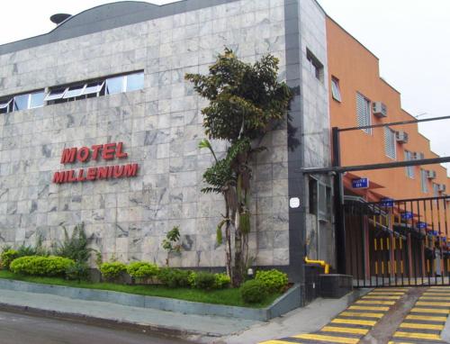 a building with a sign on the side of it at motel millenium in Betim