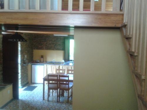 a kitchen and dining room with a table and chairs at A Cabana de Cao in Loiba
