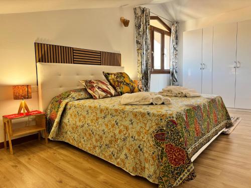 a bedroom with a bed with a colorful bedspread at La Dimora di Deborah in Montecatini Terme