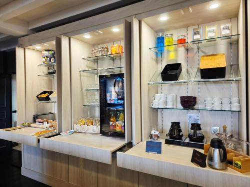 una cafetería con un mostrador con tazas de café en Logis Hôtel Restaurant Le Quai Fleuri, en Voves