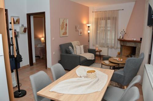 a living room with a table and a couch at Αρσινόη apartments 4 in Arachova