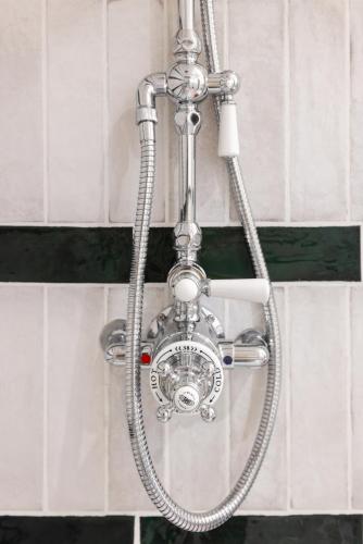 a shower head hanging from a metal pole at Hotel Ambassador, completely renovated in Nice