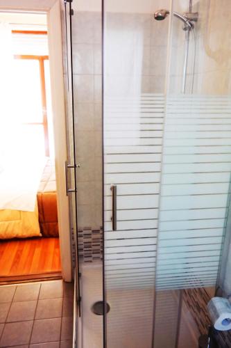 a shower with a glass door in a bathroom at Central Plaza Lecce in Lecce