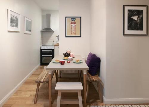 a small kitchen with a white table and chairs at Woodview Studio - Westport in Westport