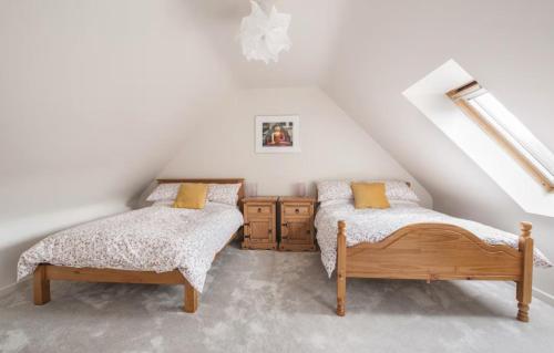 two beds in a attic room with white walls at Woodview Studio - Westport in Westport