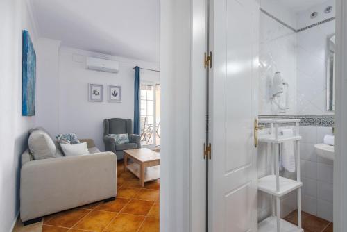 a living room with a couch and a bathroom at Playa Grande by H- Playa Punta del Moral PPHG136P111 in Isla del Moral