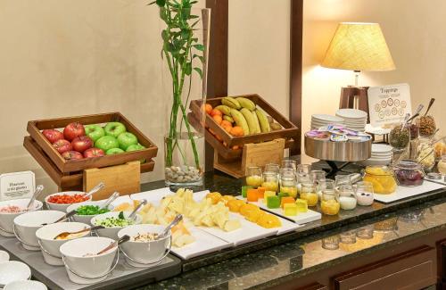 a buffet of food with fruit and vegetables on a table at NH Collection Palacio de Burgos in Burgos