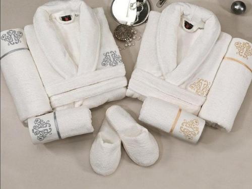 a pile of white towels and shoes on a table at VIP Apartment in Nizami street Downtown in Baku