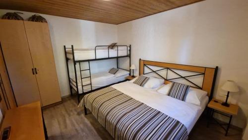 a bedroom with a bed and a shelf in it at Apartment ALFA with jacuzzi in Belá