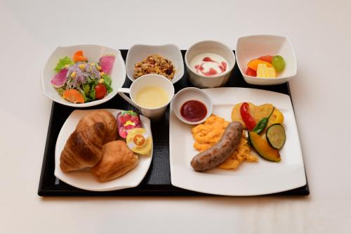 a tray of food with breakfast foods and condiments at THE RISE Osaka Universal Bayside in Osaka