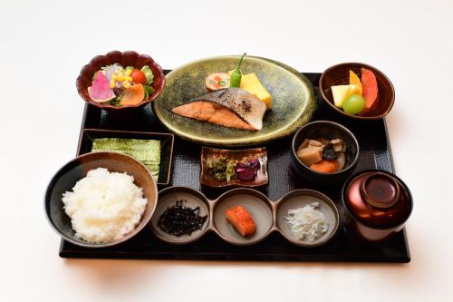a tray of food with rice and bowls of food at THE RISE Osaka Universal Bayside in Osaka