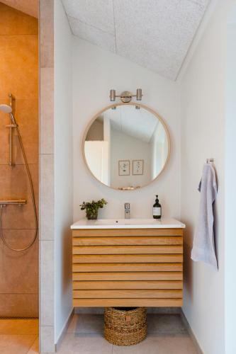 a bathroom with a sink and a mirror at Fresh Air On Open Terrace With View in Hejls