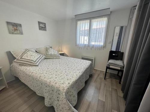 a bedroom with a bed and a chair and a window at La lande in Pontonx-sur-lʼAdour