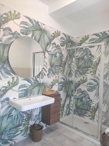a bathroom with a mural of palm trees on the wall at B&B Esotica in San Giovanni Teatino