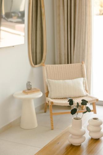 a living room with a chair and a table at Ionian Treasure Suites in EFL