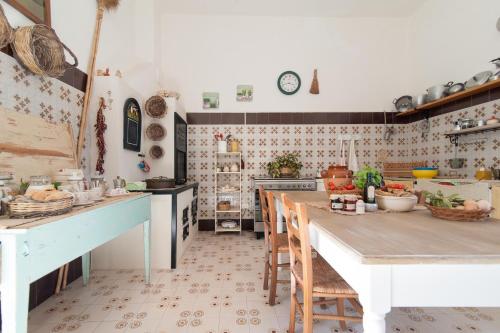 a kitchen with a table and chairs in it at Casina Grassi In Salento in Aradeo