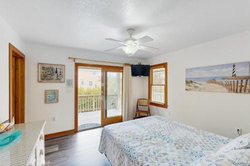 a bedroom with a bed and a ceiling fan at WV09 Play Time in Waves