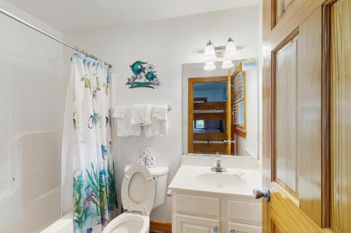 a bathroom with a toilet and a sink and a mirror at WV09 Play Time in Waves