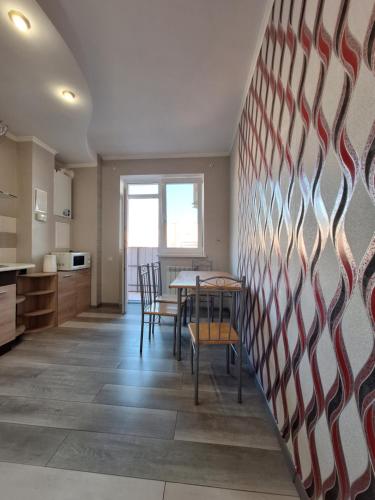 eine Küche und ein Esszimmer mit Tisch und Stühlen in der Unterkunft Однокімнатна квартира на 9 поверсі на Садовому in Shcherbani