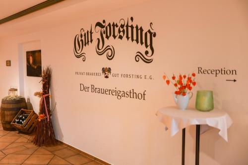 a wall in a room with a sign on it at Brauereigasthof Gut Forsting in Pfaffing