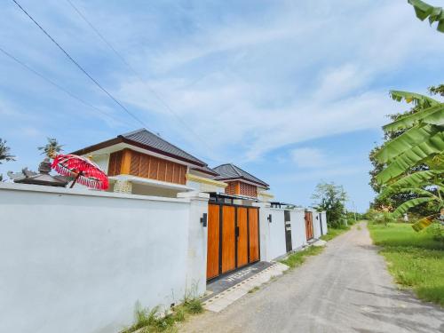 a row of houses on the side of a road at Karuna Villa with Garden in Lovina