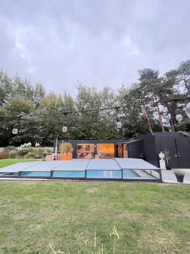 a house with a pool in a yard at Chambre d Amis in Lokeren