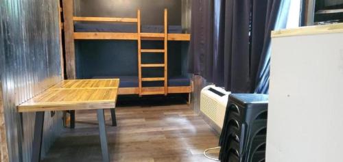 a room with a desk and a bunk bed at Relaxing Group Cabin with Fire Ring in Indiana in Stony Lonesome