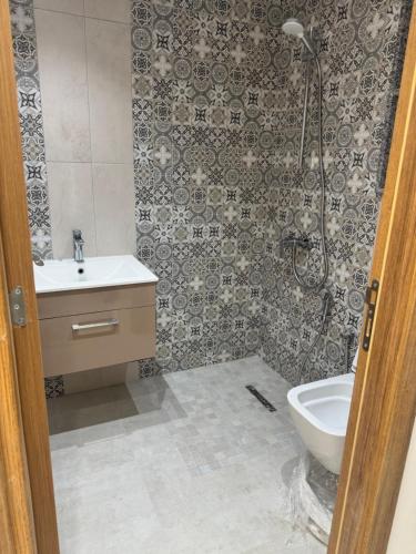 a bathroom with a sink and a toilet at La chebba plage in Chebba