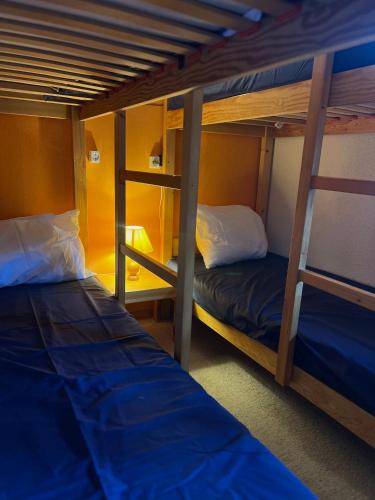 a room with two bunk beds and a ladder at Les Traverses 18 in Valmorel