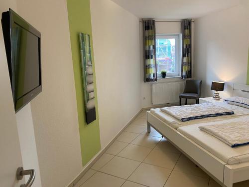 een kamer met een bed, een bureau en een raam bij Meeresbrise 14 in Wangerland