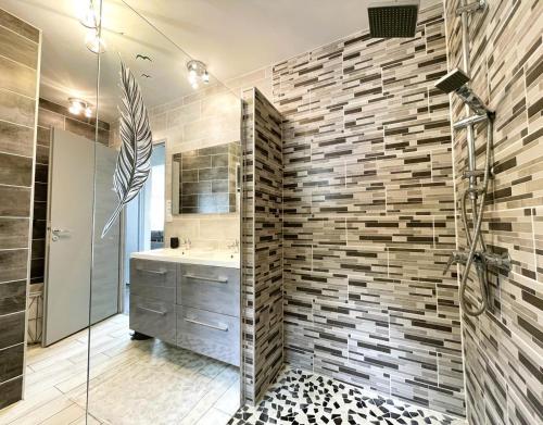 a bathroom with a sink and a glass shower at Gite l'oree du bois in Livron