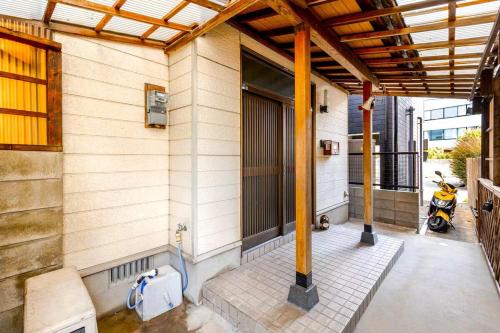 a porch of a house with a motorcycle on it at まほら in Fukuoka