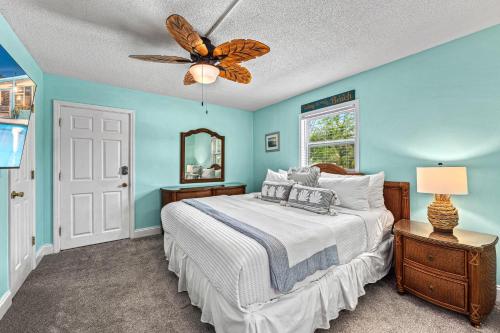 a bedroom with a bed and a ceiling fan at Plumbago - 5251C in Siesta Key