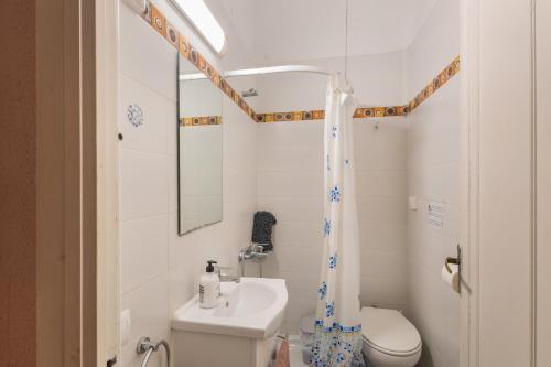 a white bathroom with a sink and a toilet at Tordera Village in Tordera