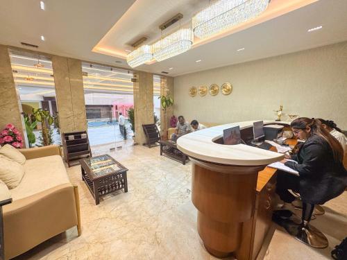 a woman sitting at a bar in a salon at The Fortunaa Avenue in Gwalior